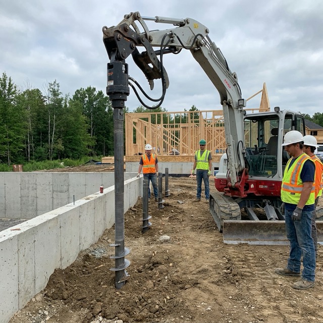 helical pier installation Florida - steel shaft screwed into stable soil for foundation support